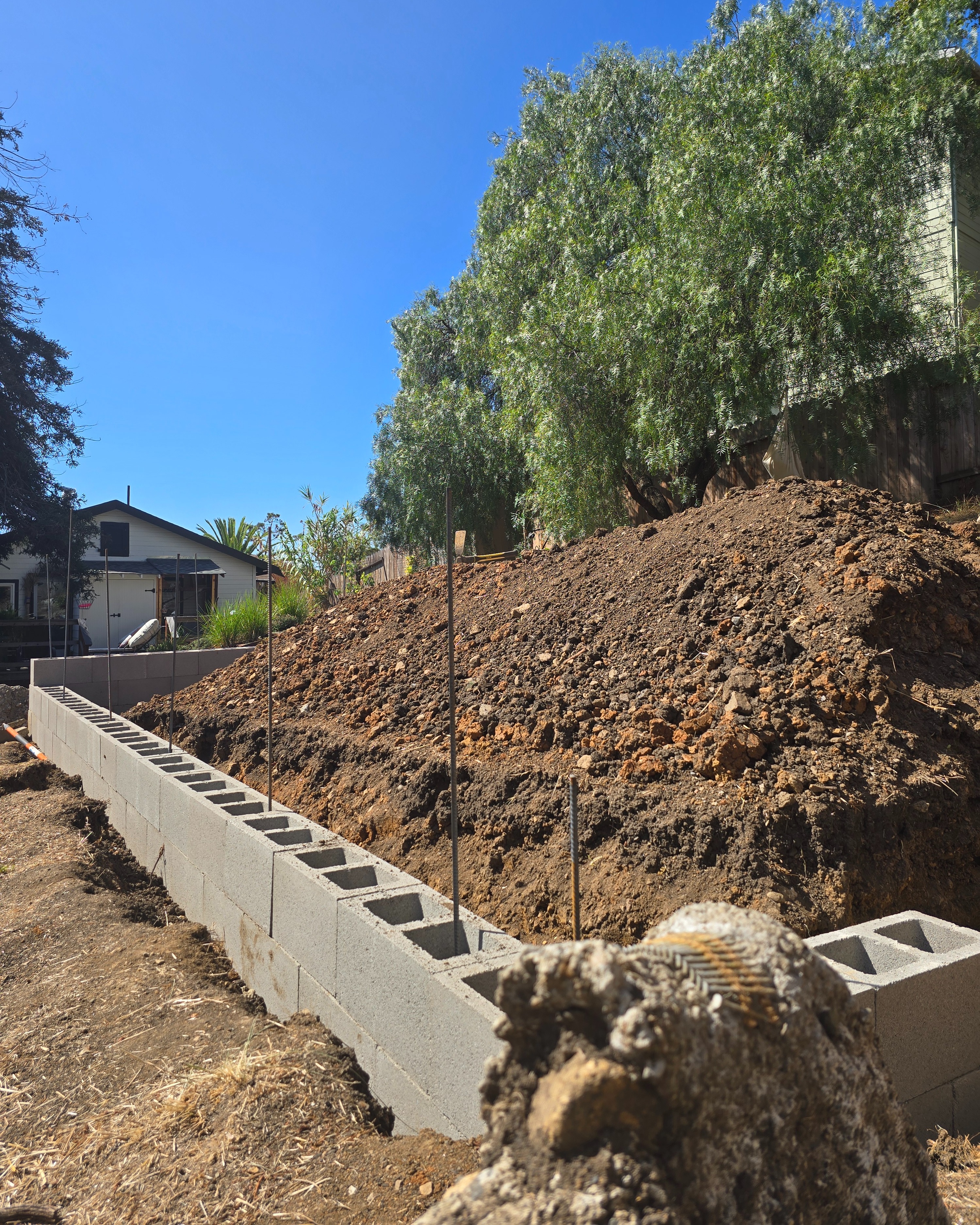Levering out the large concrete slab with digging bar
